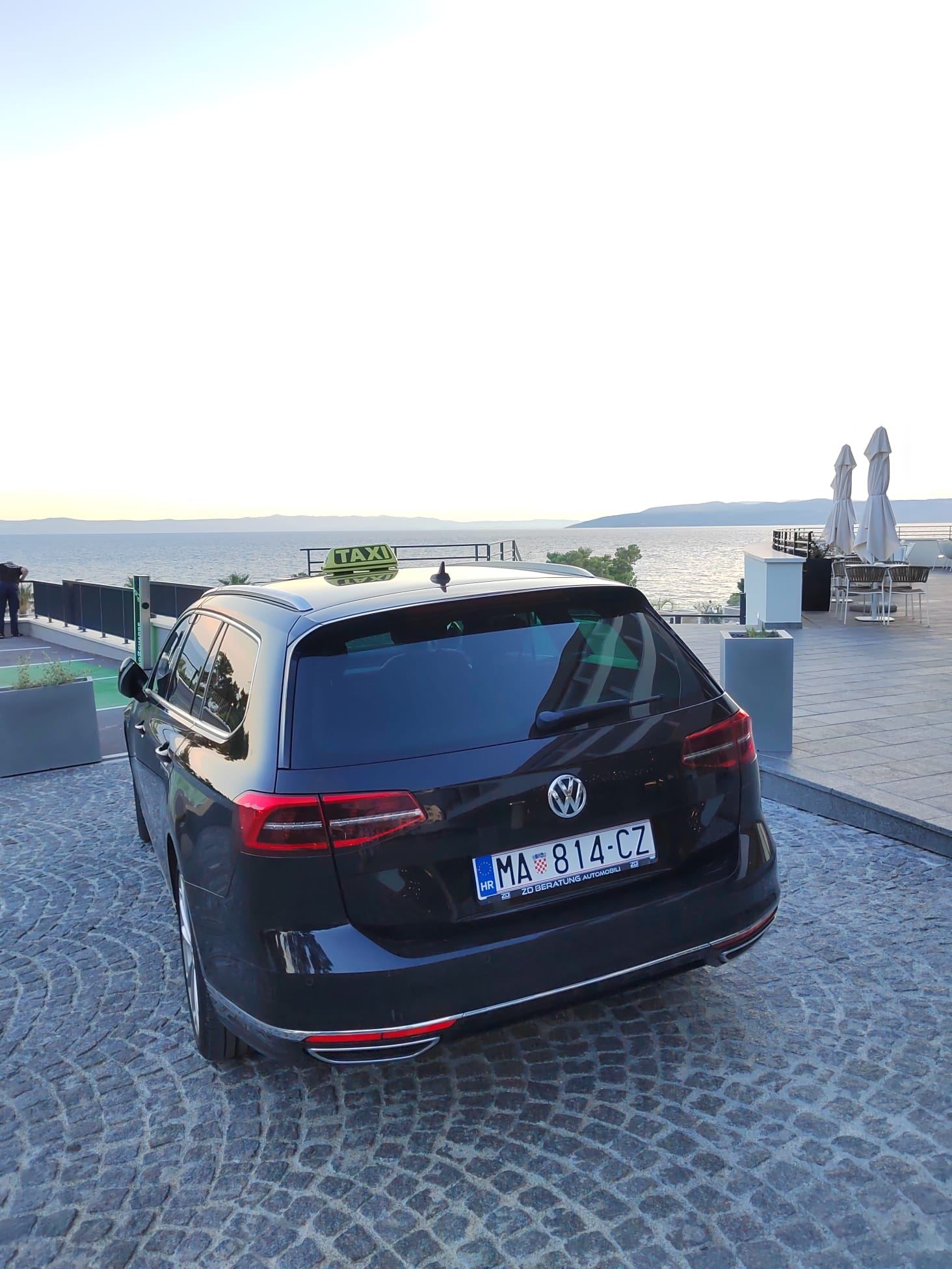 Rear view of the Eurotaxi Makarska vehicle with the sea behind it